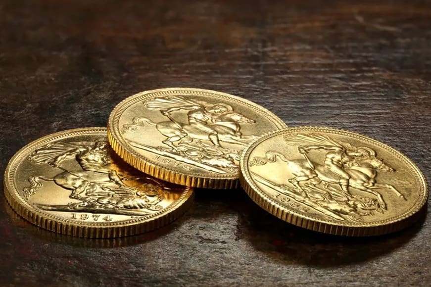 Are gold coins a good investment? three gold coins on a wooden table top