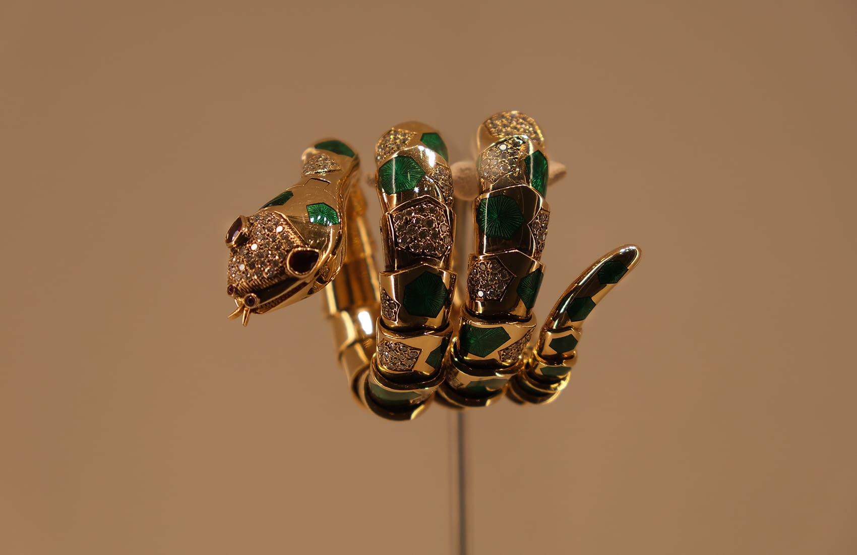 BVLGARI Serpenti bracelet watch in gold with green enamel, rubies and diamonds.
